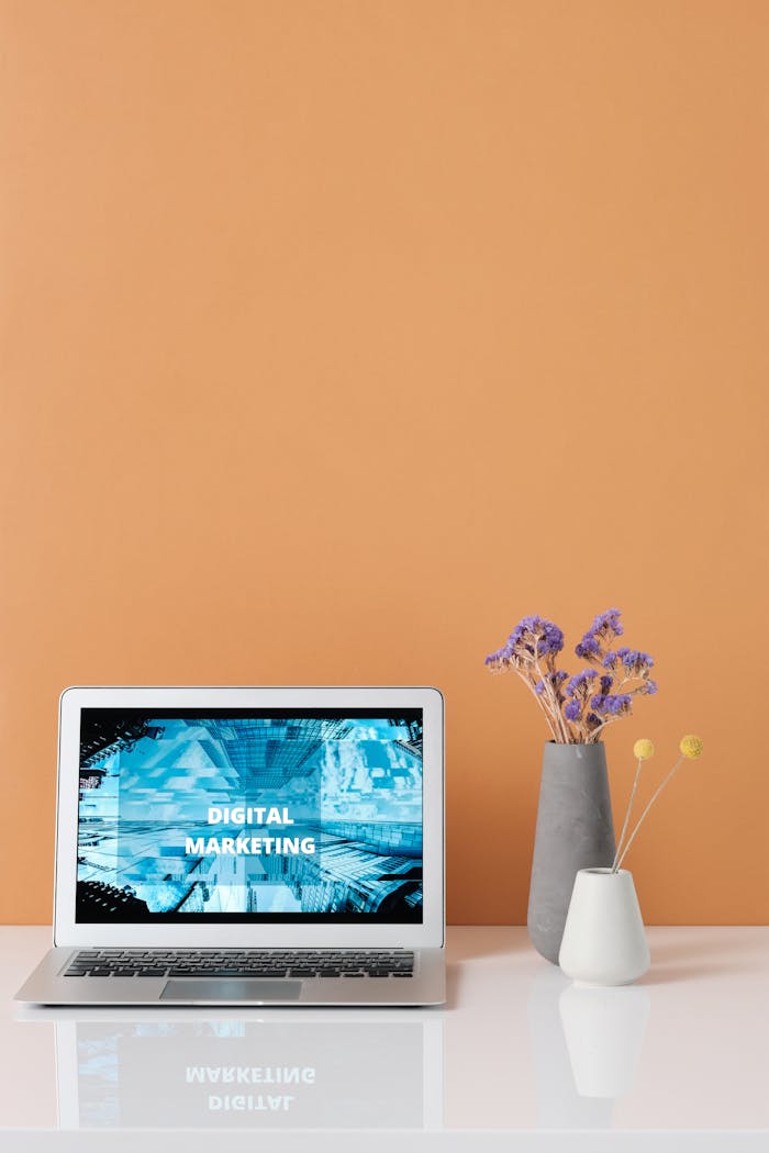 home-services-03 Modern workspace with laptop and decorative flowers showcasing digital marketing.